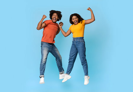 Funny african american millennials showing muscles on blue
