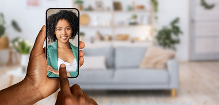 Engaging in an online video call from home with a smartphoneの写真素材