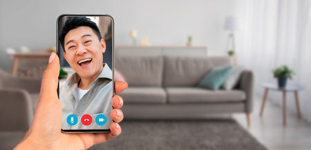 Smiling person on a smartphone video call from a cozy home setting