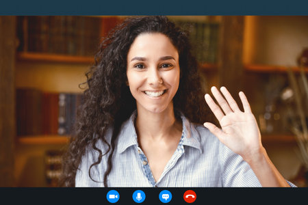 Woman waving to camera having online conference call