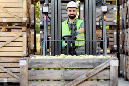 Truck is loaded with containers full of apples, ready to be sent to marketの写真素材