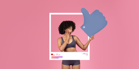 Influencer shares excitement with thumbs up in social media settingの写真素材