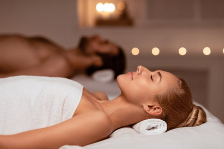 Couple Resting After Massage Relaxing In Luxury Spa With Candlesの写真素材