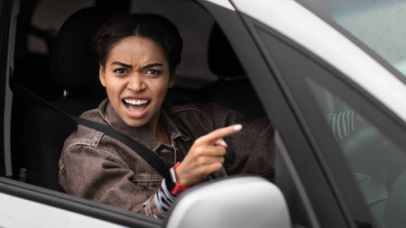 Angry, young, pissed off, displeased, aggressive african american woman shouting on drivers in front of herの写真素材