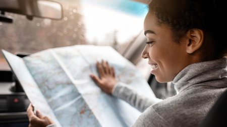 Young woman travel alone with map in car in new townの写真素材