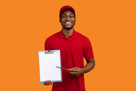 African american delivery man showing folder and penの写真素材