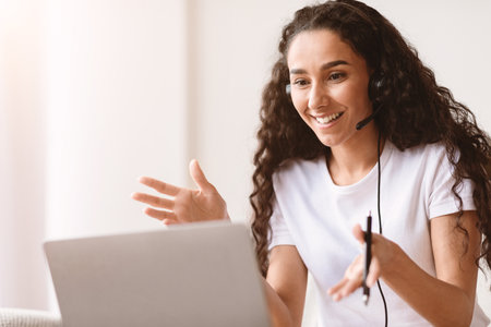 Excited young woman having video interview from home