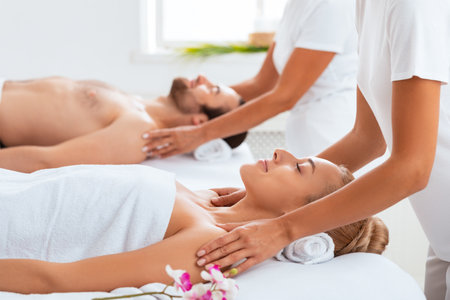 Spouses Receiving Shoulders Massage Relaxing At Luxury Spa Centerの写真素材
