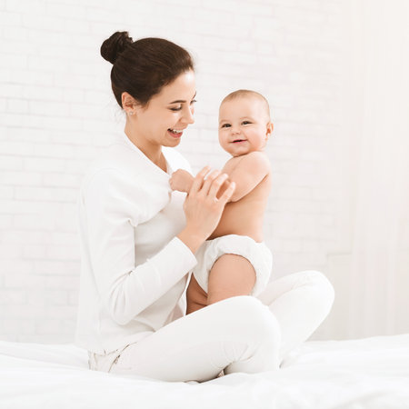Young mother hugging her cute newborn child