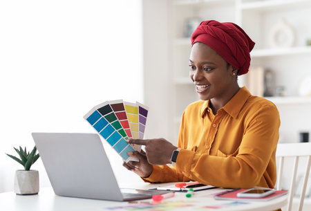 Stylish young black woman independent contractor having video conferenceの写真素材