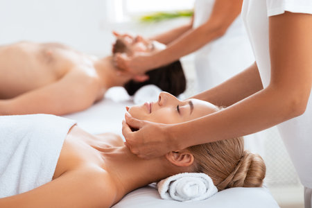 Relaxed Couple Enjoying Massage Lying Together At Spa Centerの写真素材