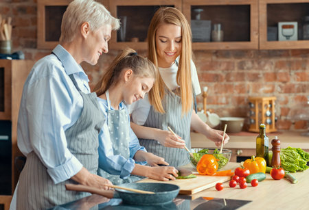 Happy adult ladies teaching little girl how to cook