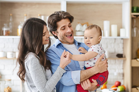 Cheerful parents spending time with adorable baby sonの写真素材