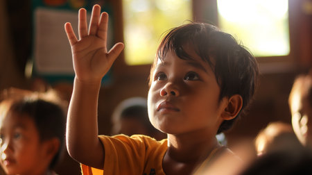 A young boy raises his hand eagerly, engaged in a lesson about rights and justice with peersの素材