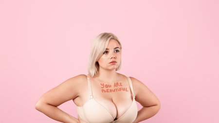 Body Acceptance. You are beautiful inscription on chest of plus size womanの写真素材