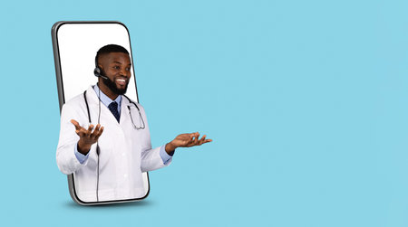 Telemedicine Concept. Black Doctor In Headset Peeking Out Of Big Smartphone Screenの写真素材