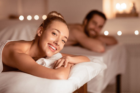 Happy Lady Relaxing At Spa With Husband, Smiling Enjoying Aromatherapyの写真素材