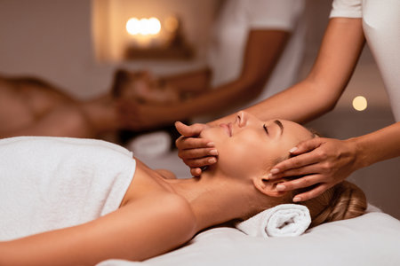 Woman Receiving Face Massage During Couples Therapy Lying In Spaの写真素材