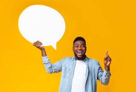 Inspired african american guy man holding empty speech bubble