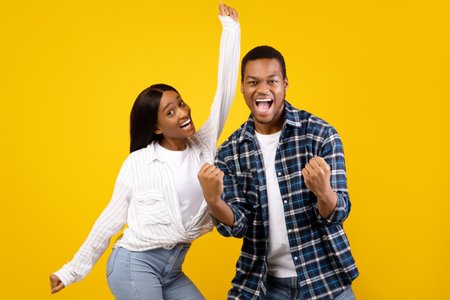Sincere expression of success young african american male and female with open mouth, screams and...