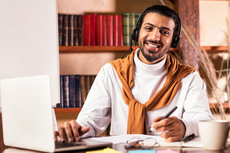 Smiling Arab Teacher Sitting At Laptop Posing In Classroom