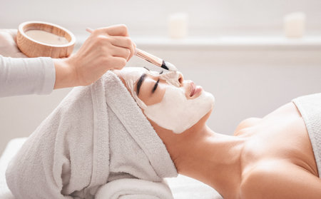 Young Korean Woman Enjoying Beauty Treatments In Spa Salon, Getting Clay Maskの写真素材