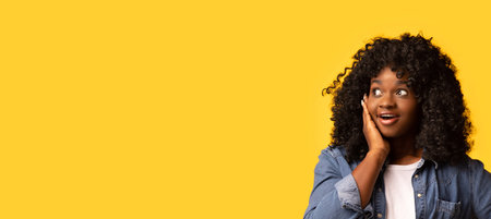 Shocked african american woman looking at empty spaceの写真素材