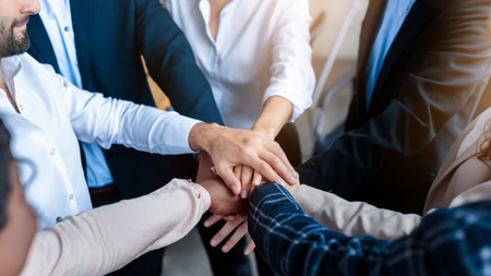 Coworkers Holding Hands During Corporate Teambuilding Meeting In Office