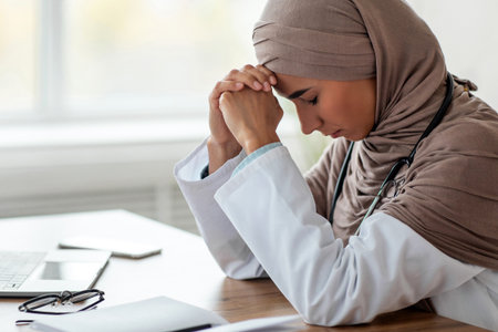 Exhausted woman doctor working in the clinic, side viewの写真素材