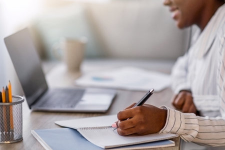 Closeup of black woman having online course, home interior