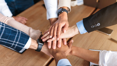 Top-View Of United Business Team Holding Hands In Office