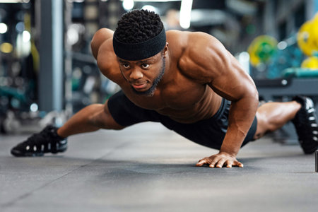 Motivated black guy bodybuilder doing some push-ups