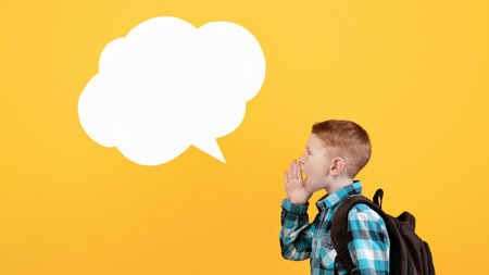 Side view of schoolboy saying something loudの写真素材