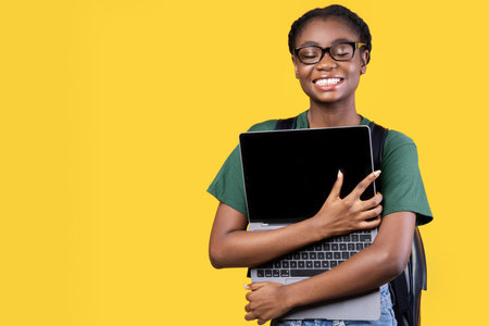 Happy Black Female Student Hugging Laptop Standing Over Yellow Background