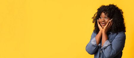 Amazed black woman looking at copy space for advertisementの写真素材