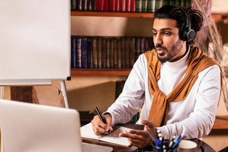 Male Teacher Having Online Lecture At Laptop Sitting At Home