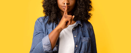 Beautiful woman doing silence gesture with her handの写真素材