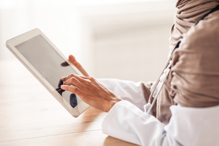 Cropped of female doctor using digital tabletの写真素材