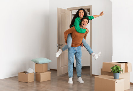 Happy man and woman having fun on moving day