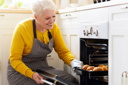 Happy Matured Woman Opening Oven at Kitchen
