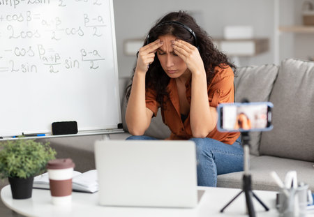 Bored and tired teacher having online lessonの写真素材