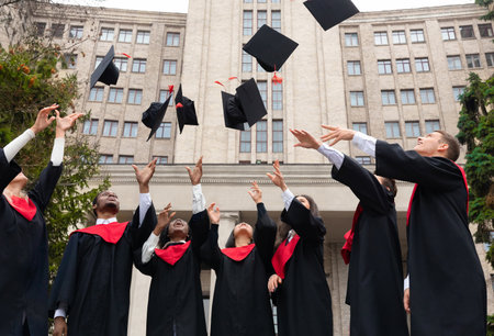 International group of students throwing graduation caps upの写真素材