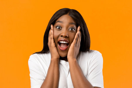 Closeup of emotional black woman showing amazementの写真素材