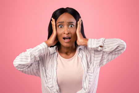No way. Shocked black woman grasping her head in disbelief over pink studio background