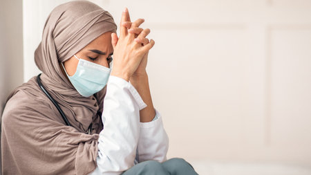 Tired muslim woman doctor having short break during working shiftの写真素材
