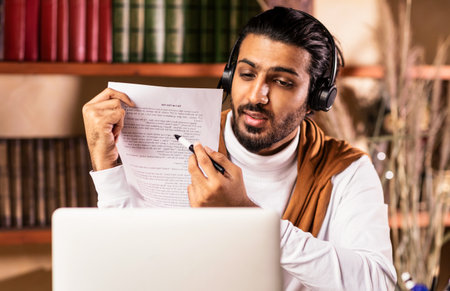 Teacher At Laptop Having Online Class With Remote Students Indoors