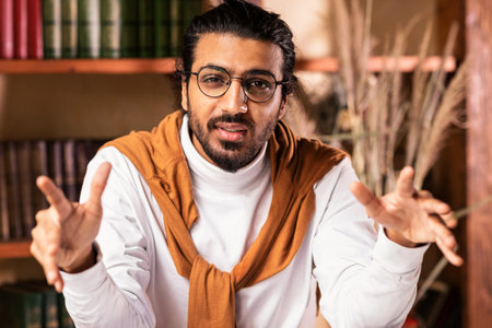 Arab Teacher Man Talking To Camera Sitting In Living Room