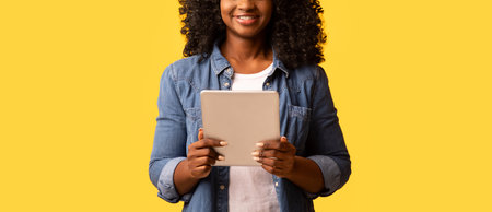 Happy beautiful black woman using modern digital tabletの写真素材