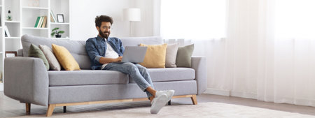 Remote Work. Smiling Indian Freelancer Guy Working With Laptop At Home