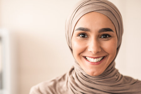 Portrait of cheerful woman in hijab over clinic interiorの写真素材
